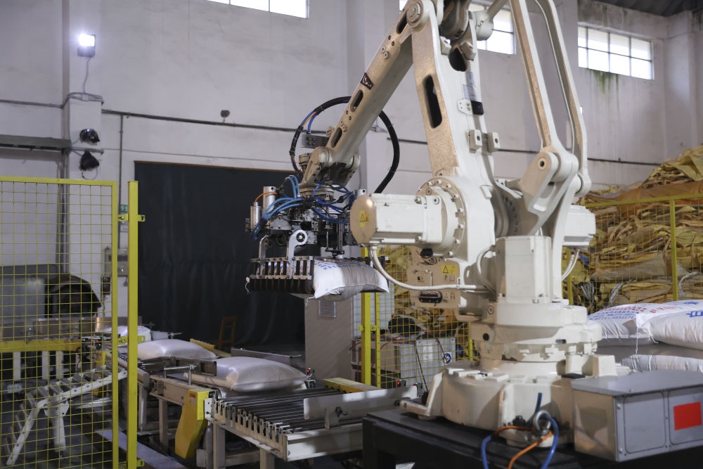 12月14日，在廣西來賓東糖鳳凰有限公司，機(jī)械臂在廠房碼放白砂糖成品。