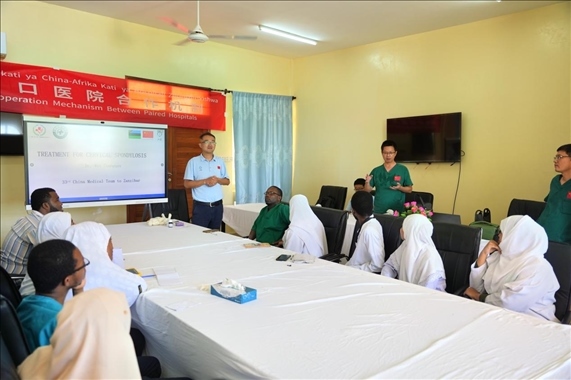 隊長蔣國慶和韋長群醫(yī)生一起解答問題。中國援桑醫(yī)療隊供圖