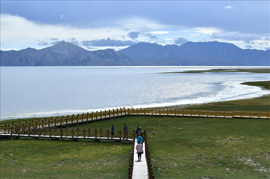 △ 游客行走在青海瑪多縣冬格措納湖畔的木棧道上。