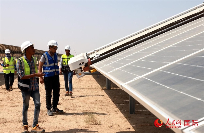 工作人員在測(cè)試自動(dòng)清掃機(jī)器人。人民網(wǎng)記者管克江攝