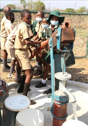 △2021年11月，在津巴布韋南馬塔貝萊蘭省省會(huì)關(guān)達(dá)的塞農(nóng)多小學(xué)，學(xué)生從中國援建水井里打水。