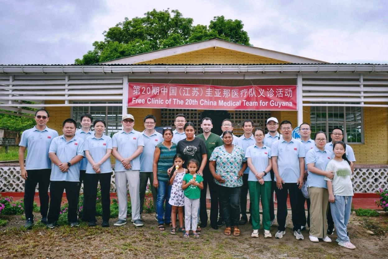 第20期中國（江蘇）援圭亞那醫(yī)療隊(duì)在圭偏遠(yuǎn)的林登高速社區(qū)開展義診后，與部分當(dāng)?shù)鼐用窈嫌啊?中國援圭醫(yī)療隊(duì)供圖
