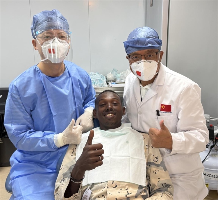 援吉醫(yī)療隊口腔科王瑋主任與“和平方舟”號醫(yī)院船醫(yī)務人員共同為一名當?shù)匮浪柩谆颊咴\療。中國（山西）第23批援吉布提醫(yī)療隊供圖